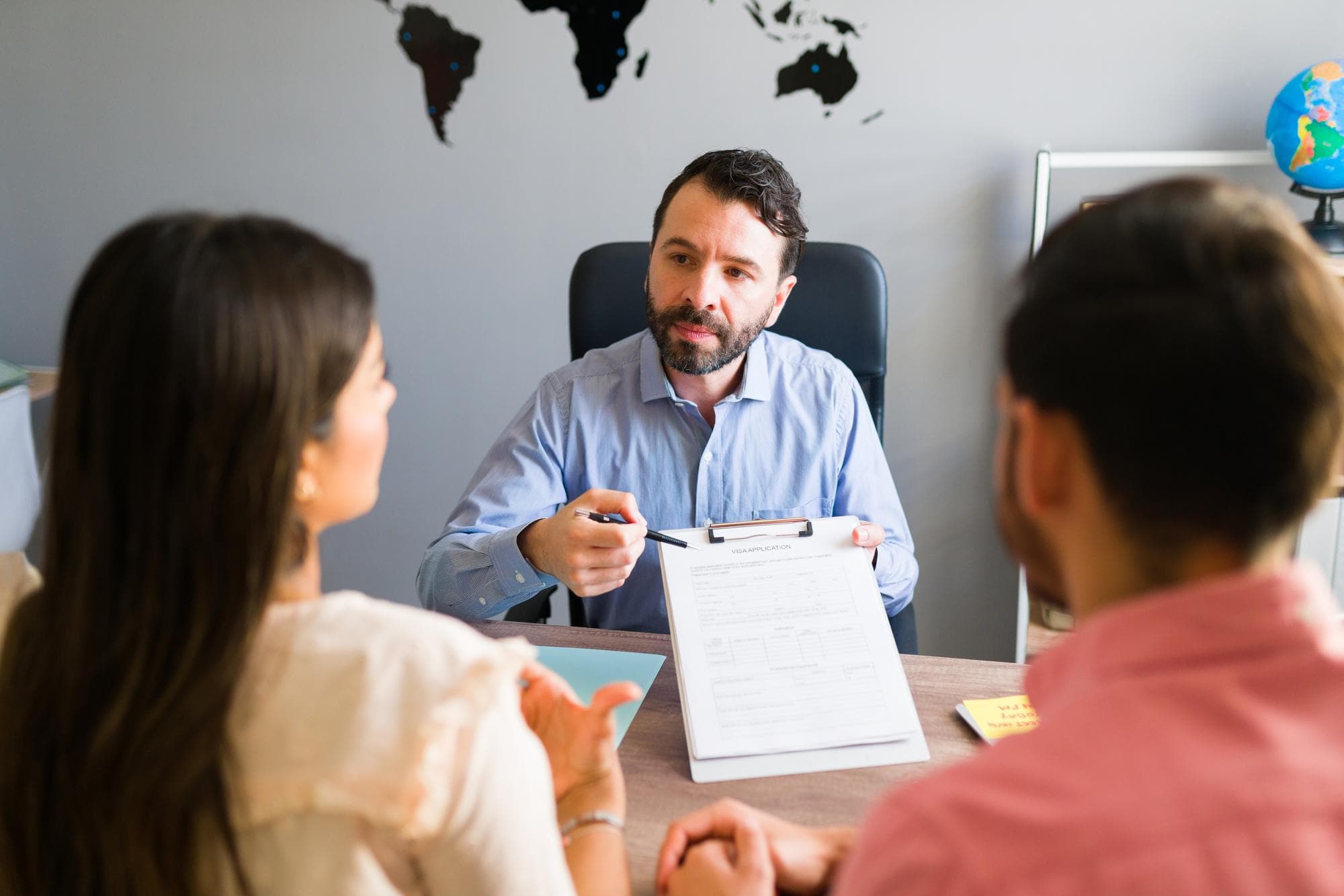 A counselor discussing an application with students