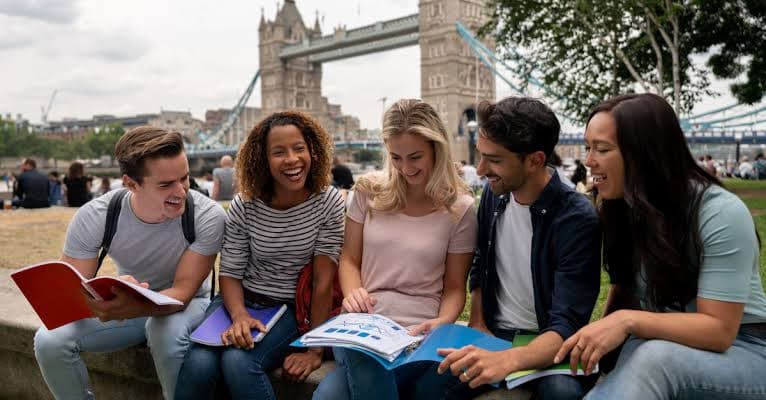 A group of international students studying near Tower Bridge
