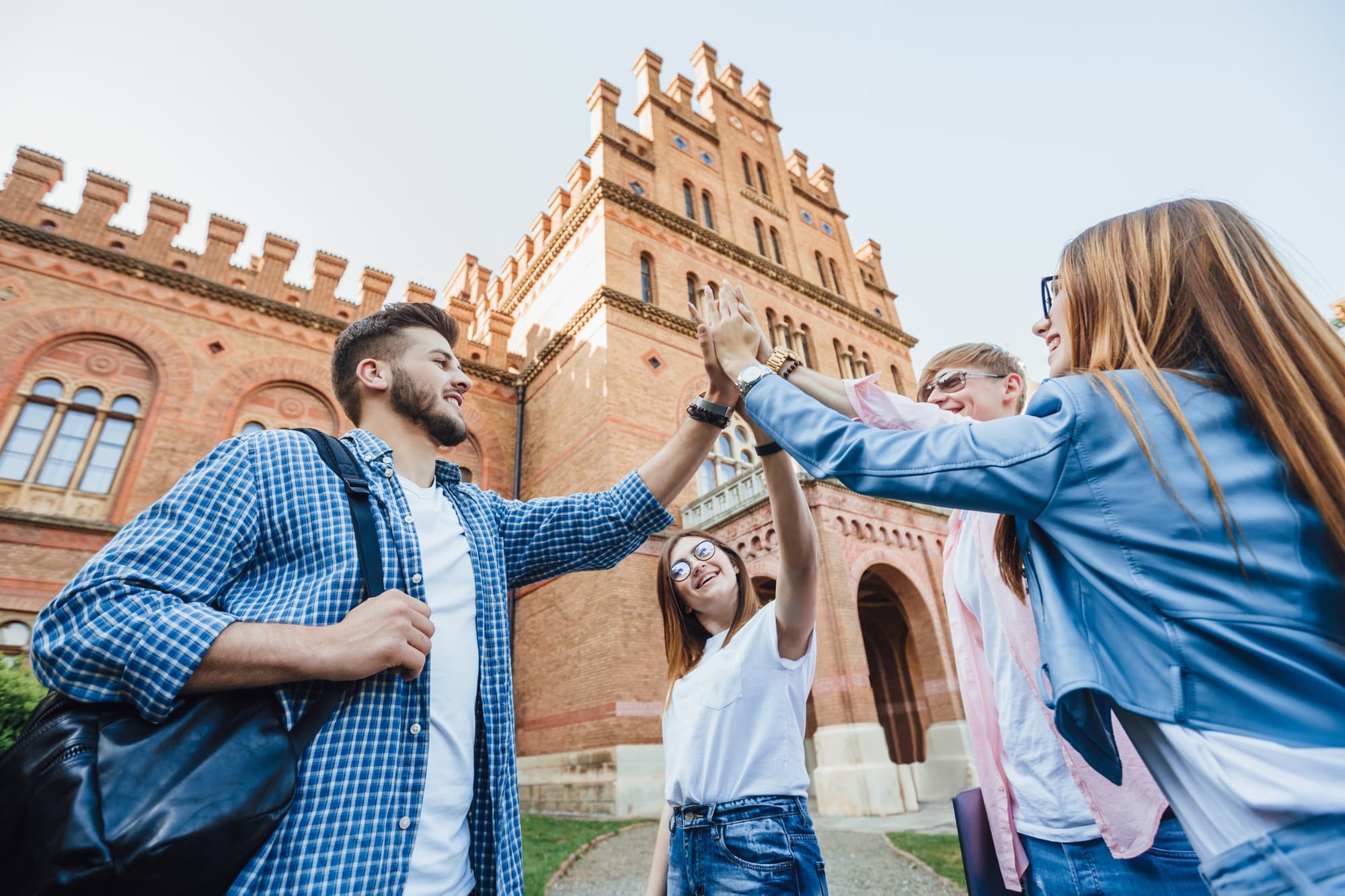 Students celebrating together outside a university
